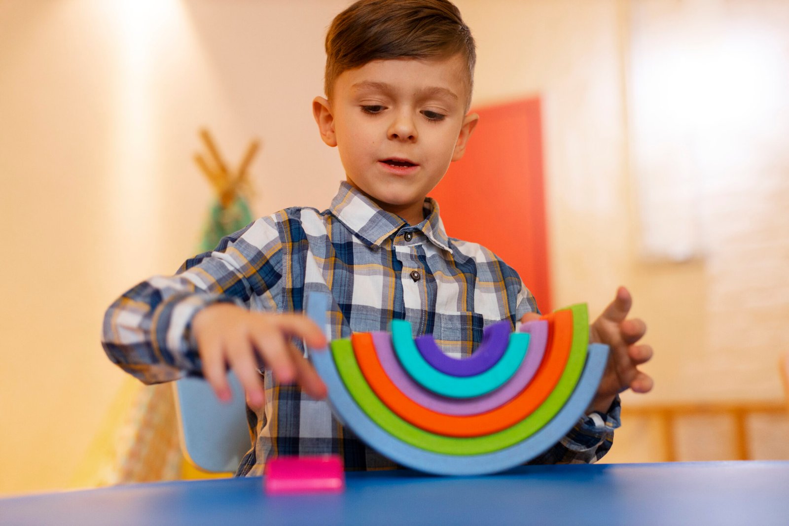 young boy playing indoors with eco toys